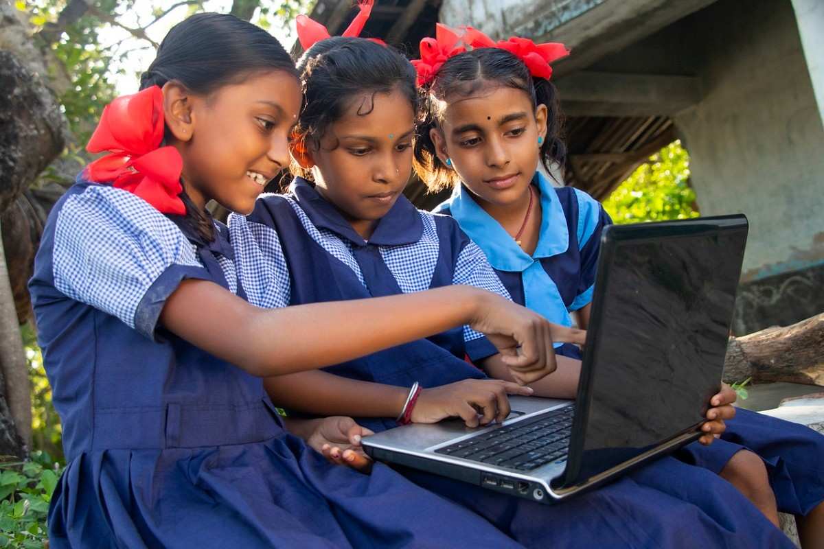 Children learning together with a laptop